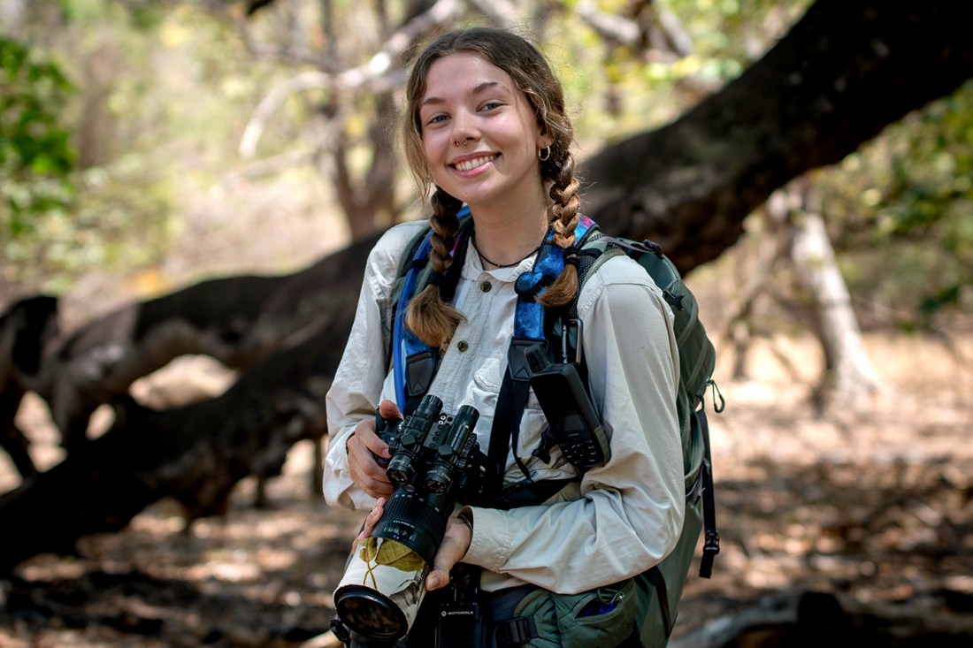 Leah Orman carrying a scope and a backpack in Costa Rica.