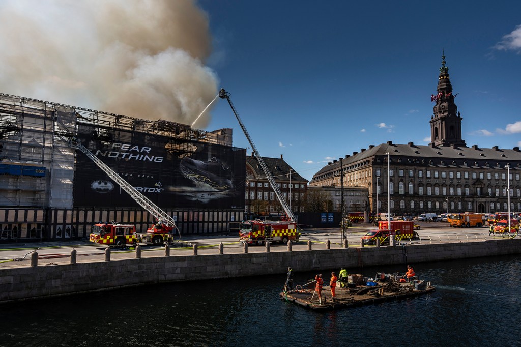 Firefighters spraying water on the Old Stock Exchange in Copenhagen.