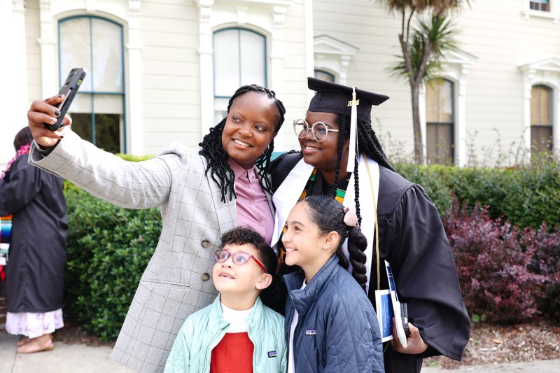 A family of four takes a selfie. 