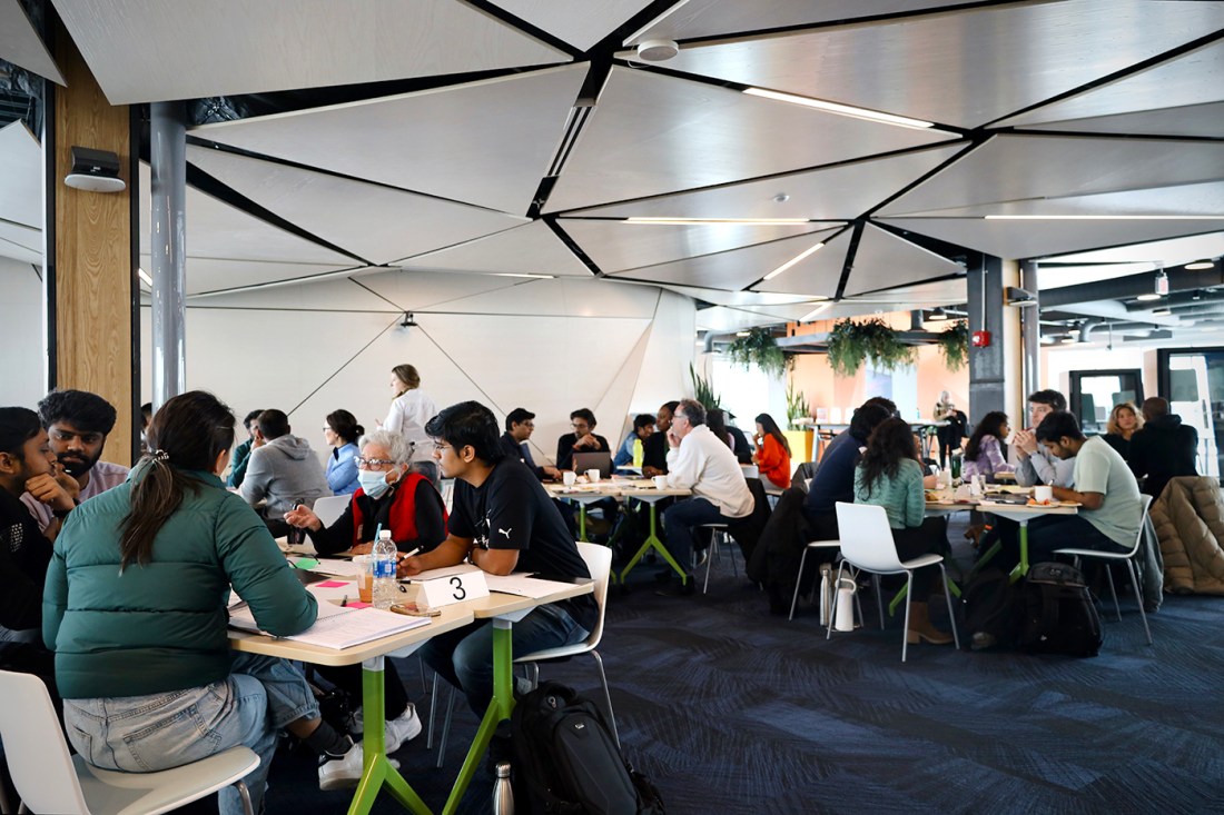 People sitting at tables at an event in Portland.