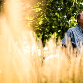 Denis Sullivan standing in a field.