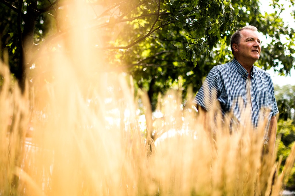 Denis Sullivan standing in a field.