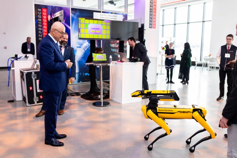 President Aoun looking at a robot. 