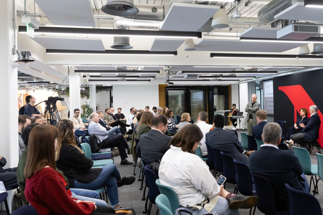 A room full of audience members listening at the Internet and Society conference.