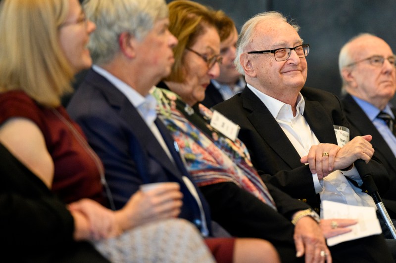 Audiences members wearing name tags listening at the Barnett Institute 50th Anniversary.