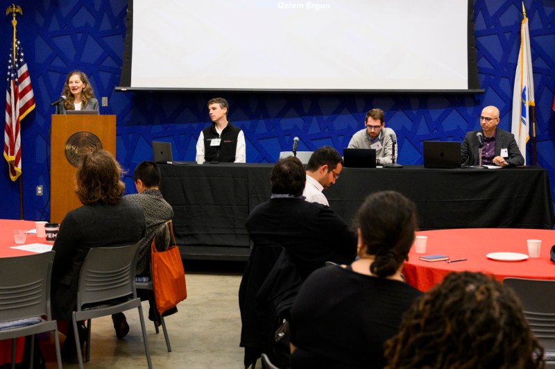 Ozlem Ergun speaking at a podium during the Algorithmic Workplace event.