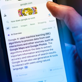 A person holding their iPhone open to an AI search result in Google.