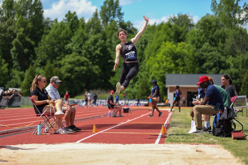 Dominique Beron competing in long jump.