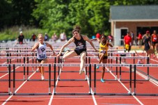 Dominique Beron jumping over a hurdle.