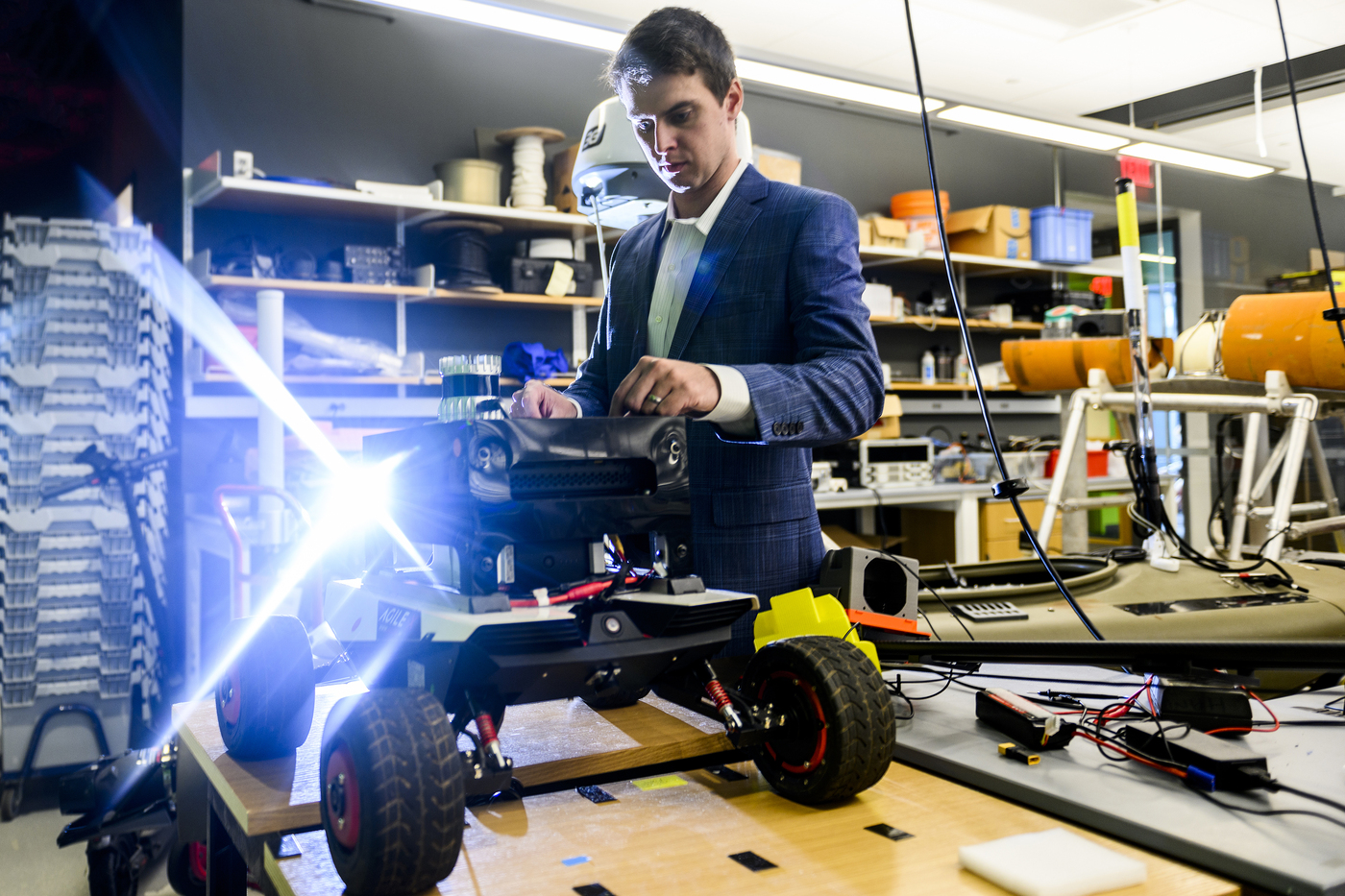 Michael Everett working on a robot in a lab.