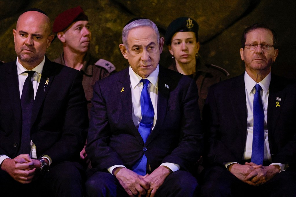 Israeli leaders sit together while wearing black suits and bright blue ties.