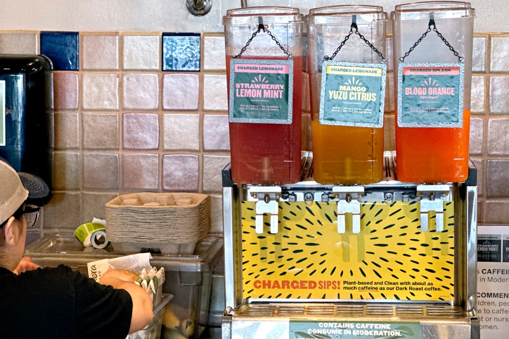 A fountain station of Panera's ‘Charged Lemonade’ drinks on a counter.