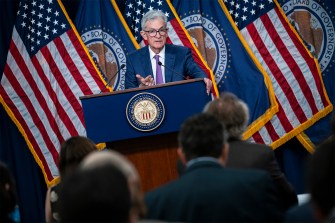 Jerome Powell at a podium during a press conference.