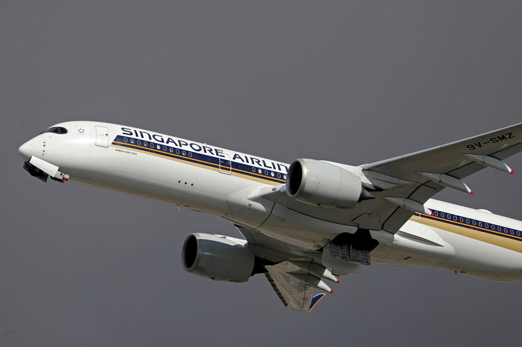 A Signapore airlines plane in the sky.