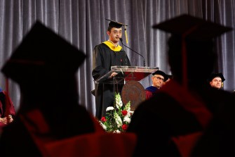 Student speaking at the podium in front of a microphone at the 2024 Vancouver Convocation.