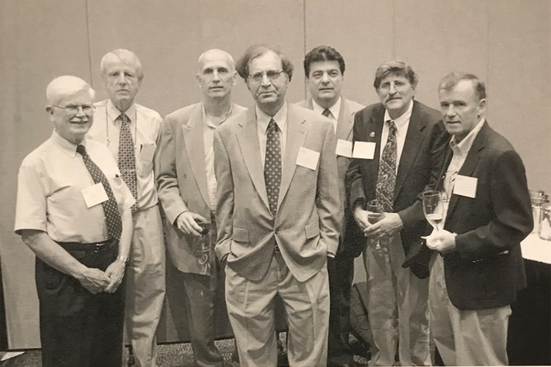 A black and white photo of Pran Nath and several other professors.