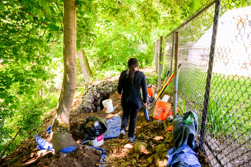 People are outside digging at an archeological dig site.