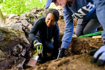 A UNH researcher digging.