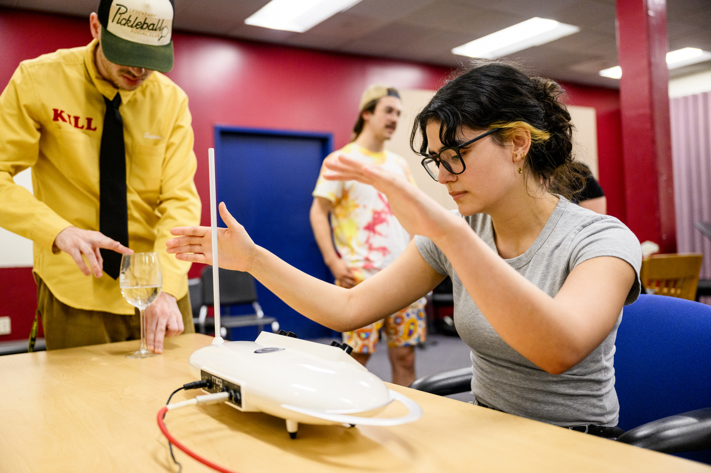 Students using different historical musical instruments and techniques.