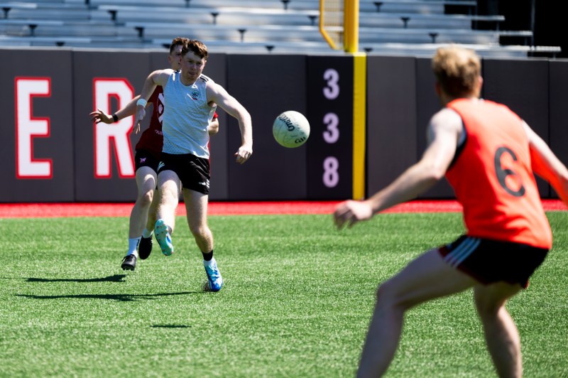 Queen's University Belfast men's gaelic football team practicin gon Parsons field.