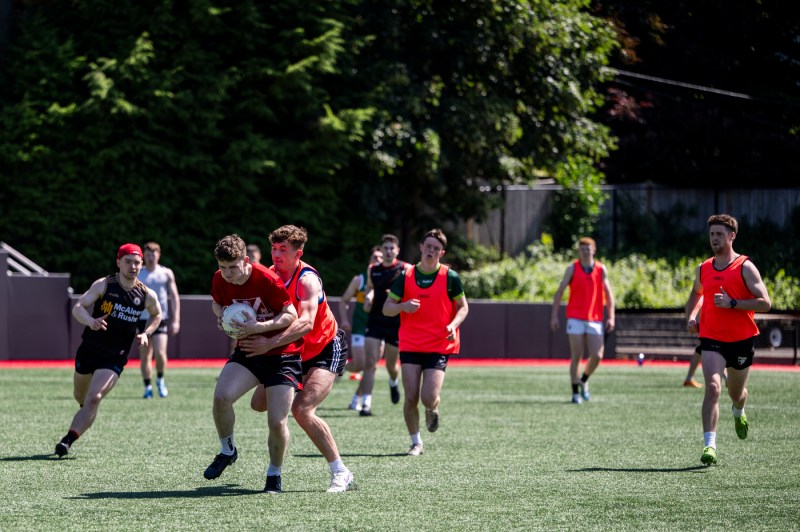 Queen's University Belfast men's gaelic football team practicin gon Parsons field.