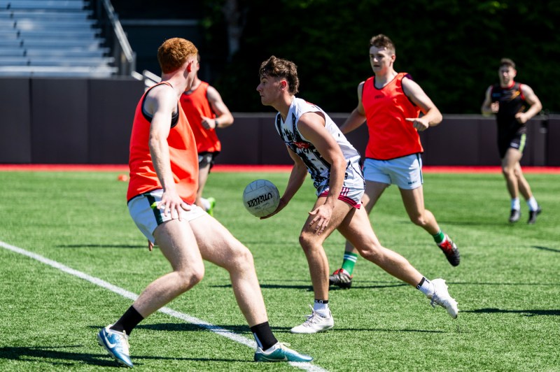 Queen's University Belfast men's gaelic football team practicin gon Parsons field.