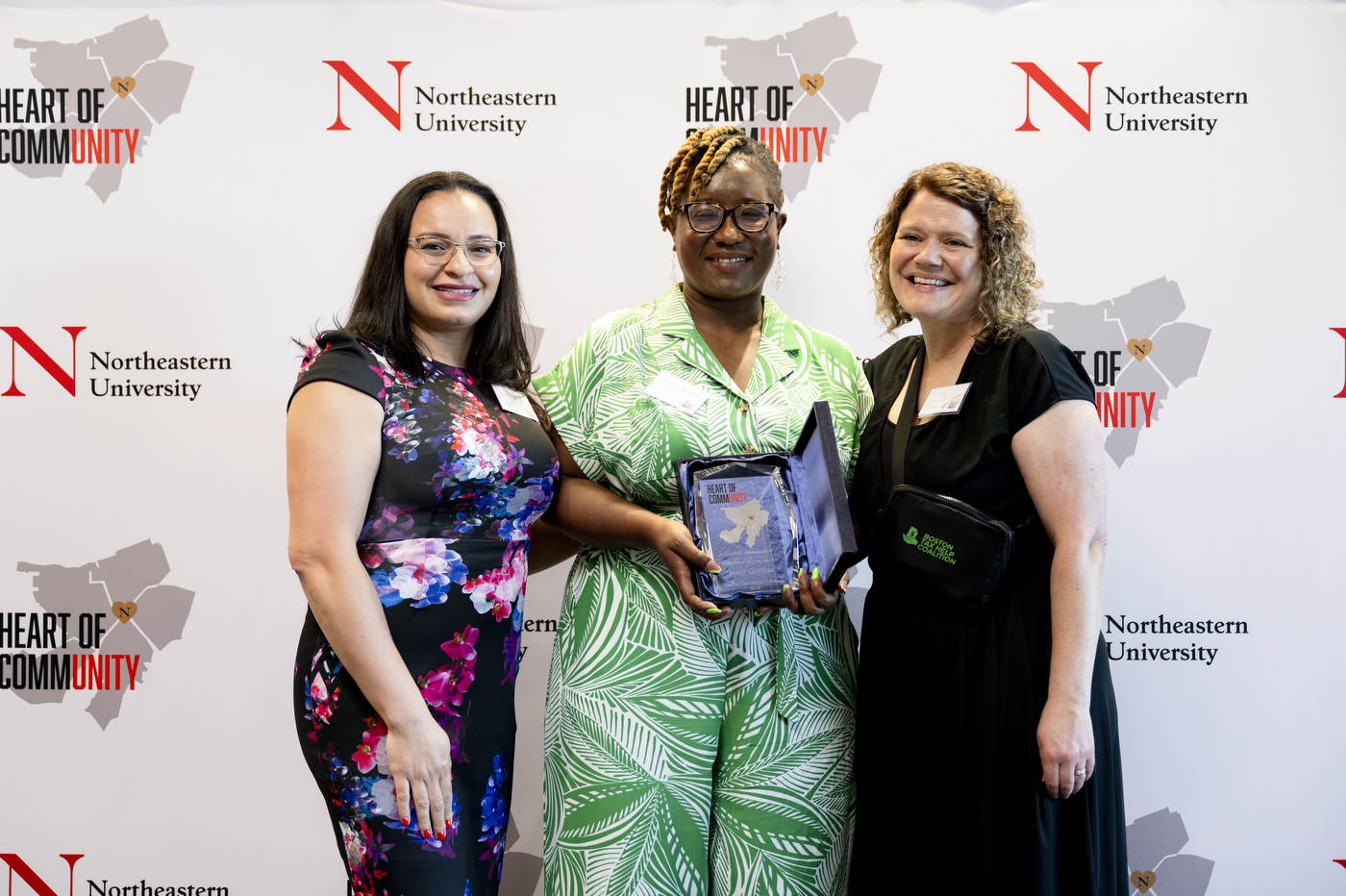 Three people posing with an award at the CommUNITY Awards 2024.