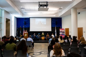 A room full of audience members listening to panel speakers at the 2024 Juneteenth celebration at Northeastern.