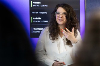 Alice Helliwell speaking and gesturing at a panel at the Adobe offices in London.