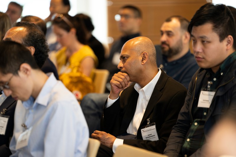 An audience member listening intently at the fireside chat with chess grandmaster Garry Kasparov.