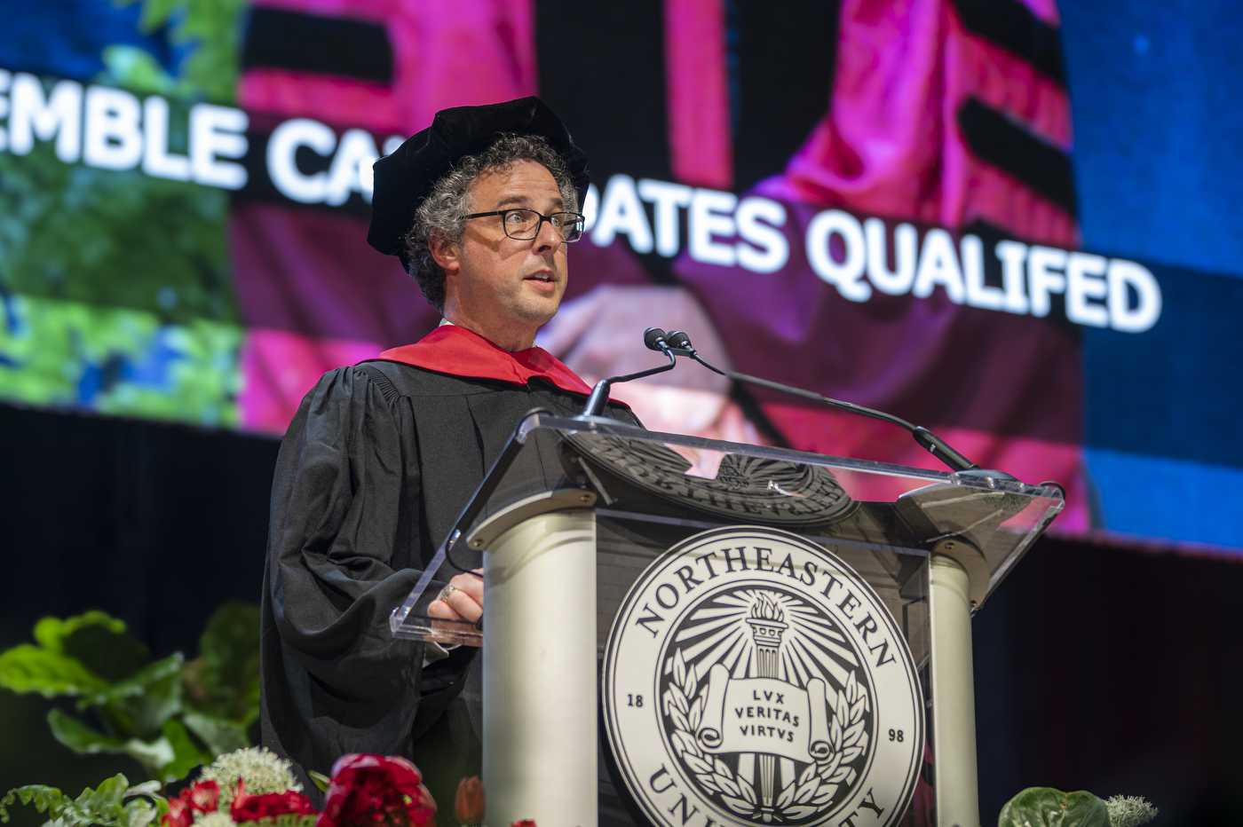 Bob Montgomery-Rice speaking on stage at the Roux Institute commencement 2024.