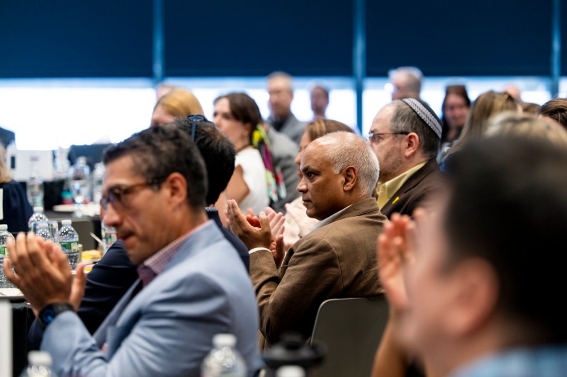 Audience members clapping at the Public Health Technology summit. 