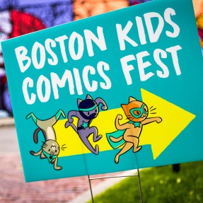 A turquoise sign that says 'Boston Kids Comics Fest' with a yellow arrow and three comic cats pointing to the right.