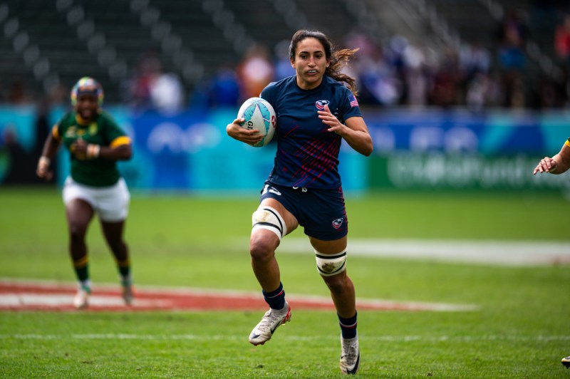 Sarah Levy running with the rugby ball.