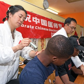 A student receiving a traditional Chinese medicine therapy.