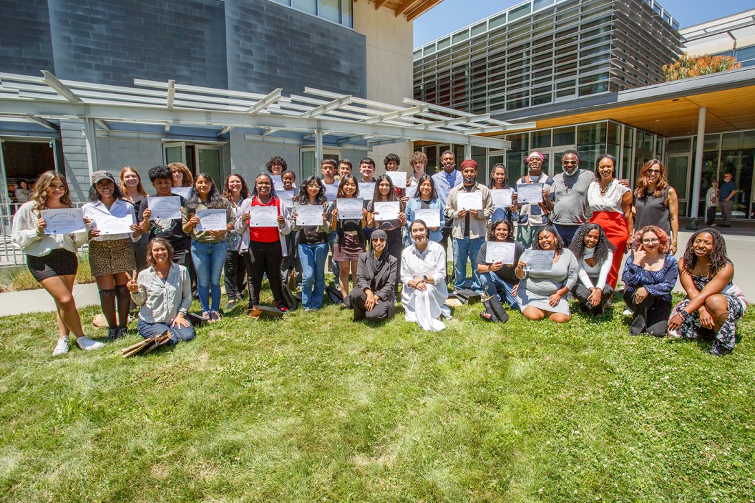 Students posing with certificates they received at the Summer Youth Employment Program.