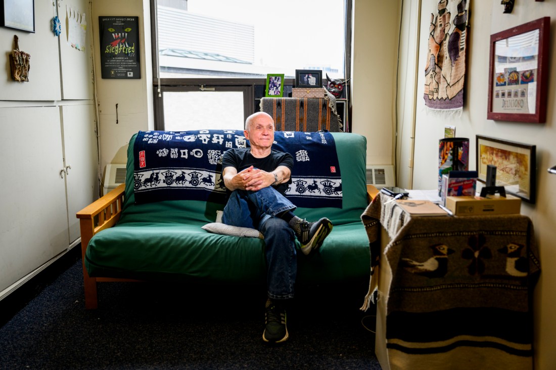 Solomon Jekel sitting on a green futon.