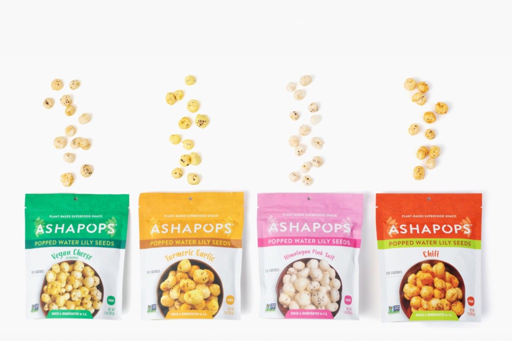 Four pouches of differently flavored AshaPops on display spill out their popped water lily seeds.