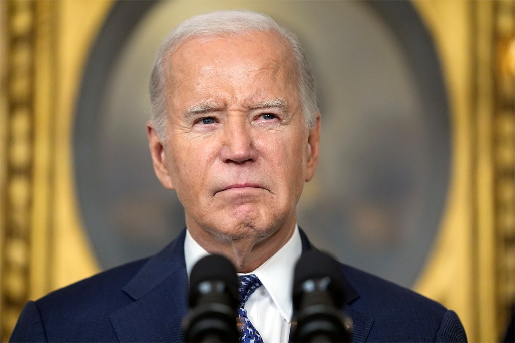 Joe Biden in front of a microphone.