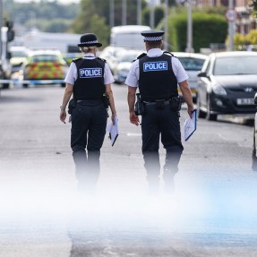 Two police officers walking down the street in Southport.