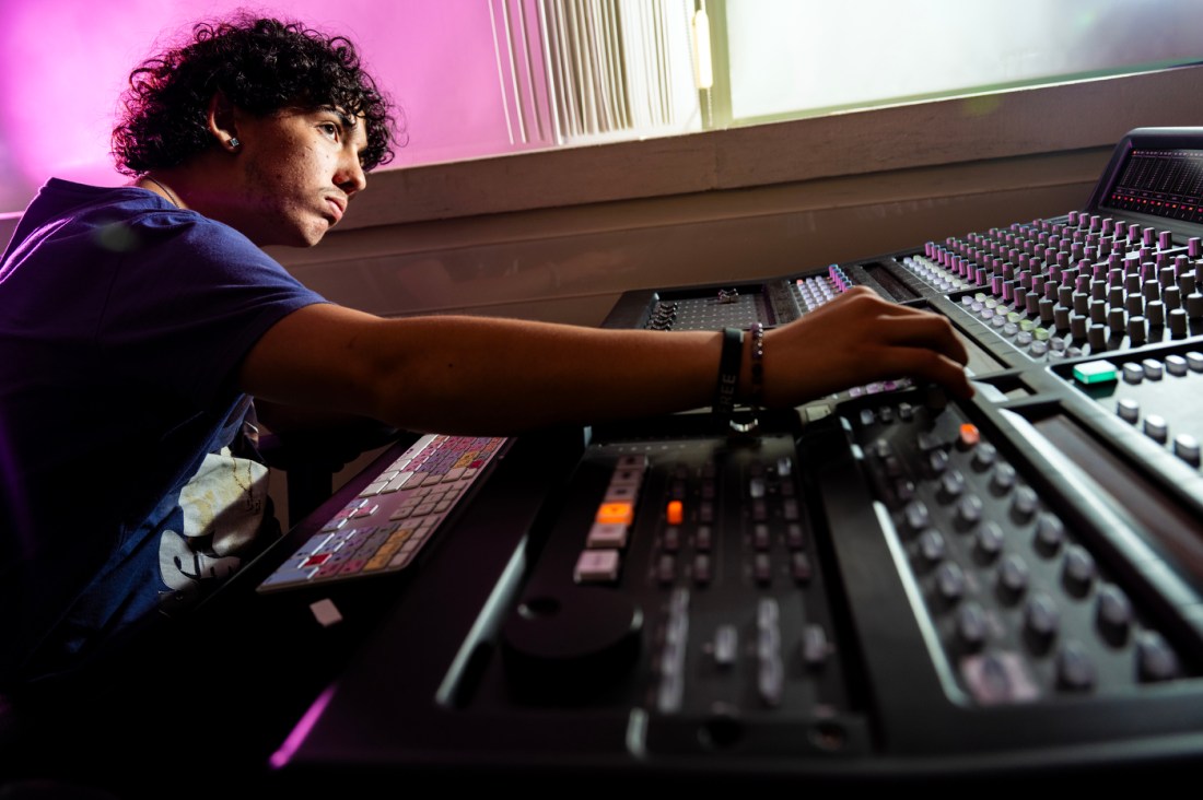 Javier Arroyo Lomon working the board in a recording studio. 