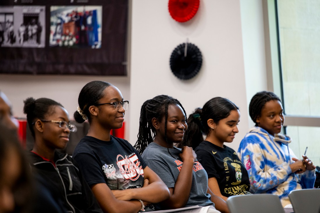 Youth interns watching a presentation. 