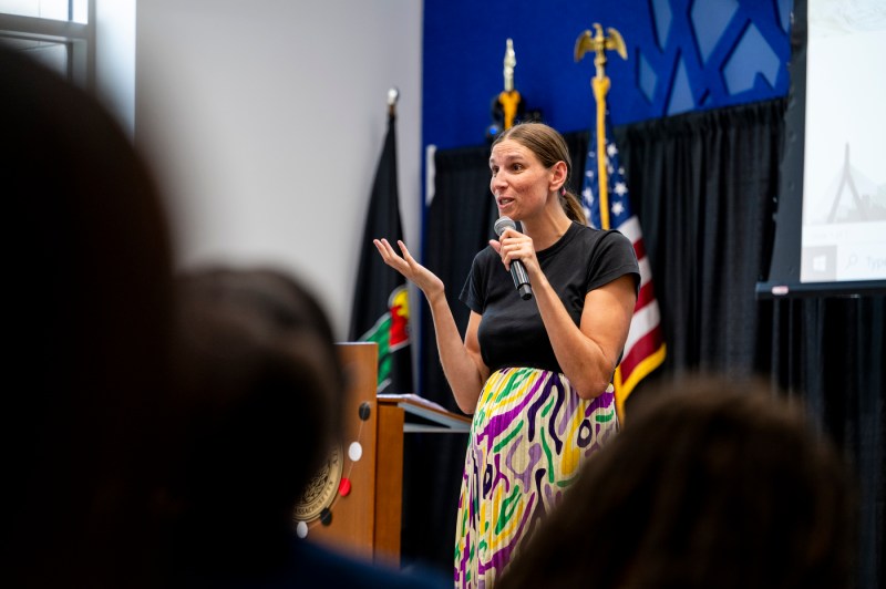 Allison Vernery speaking into a microphone. 