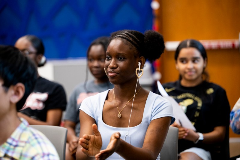 A youth intern listening to a presentation. 