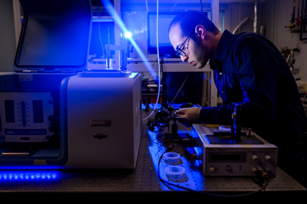 Soheil Farazi working on microchip research in a lab.