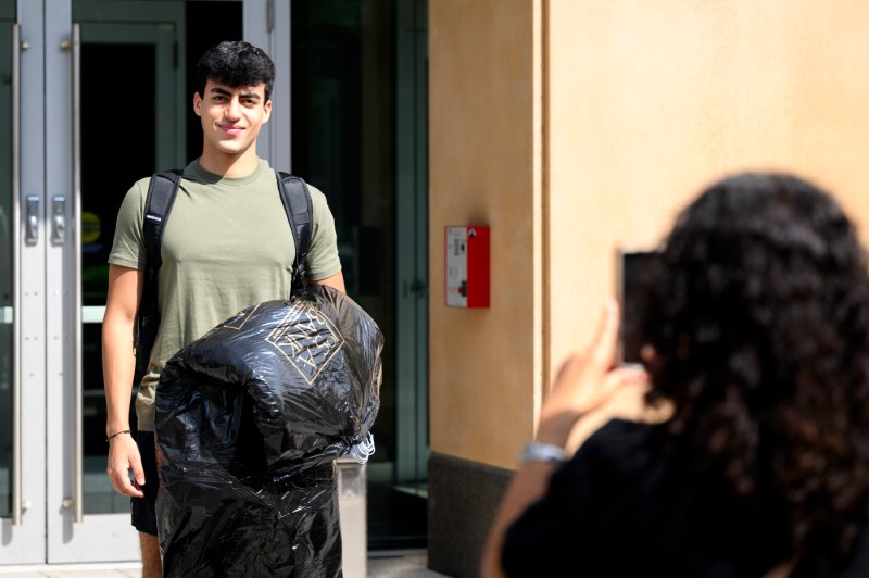 A student posing for a family member's photo. 