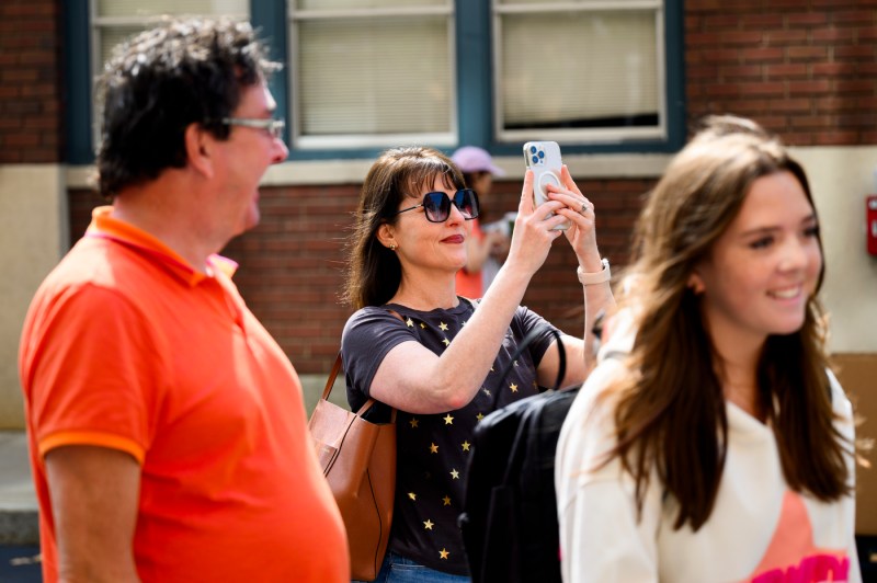 A family member taking a photo during move-in.