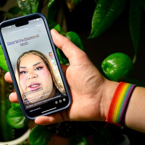 A person holding up a phone displaying a Jools Lebron TikTok video.