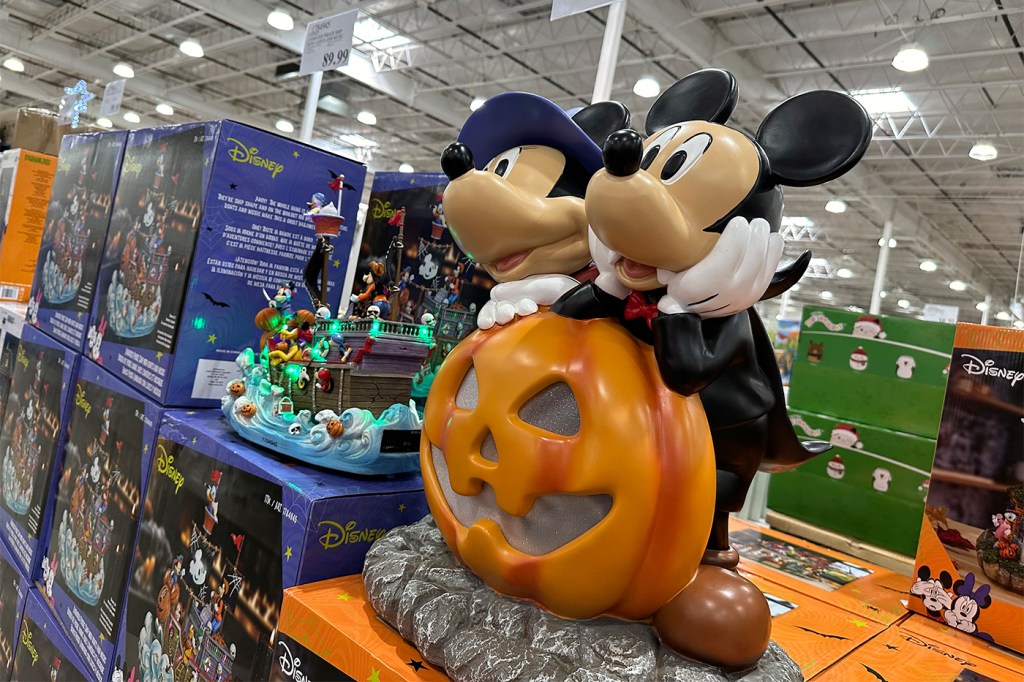 A Halloween decoration with Mickey Mouse on top of a Jack-o-Lantern.