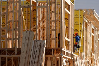 A worker building a home under construction.